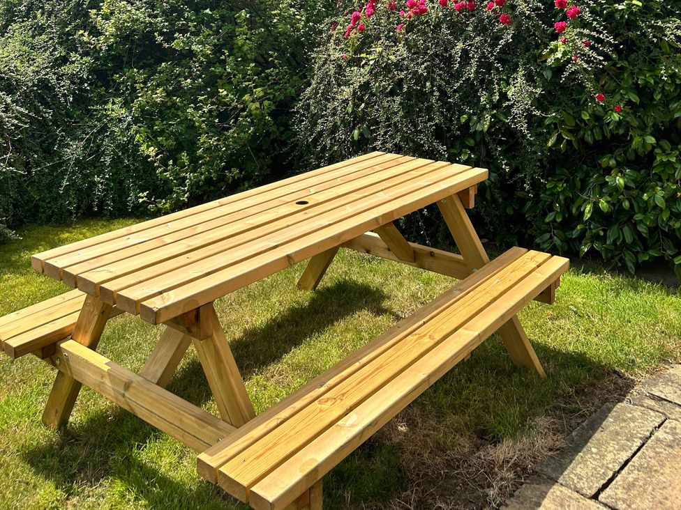 A picnic table with benches in a garden at Broadhay Offerton near Hathersage