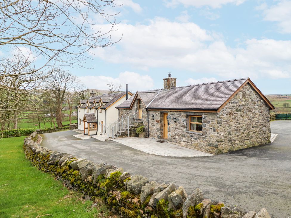 A house with a stone exterior and a driveway at Briws and 963354 together they sleep 35