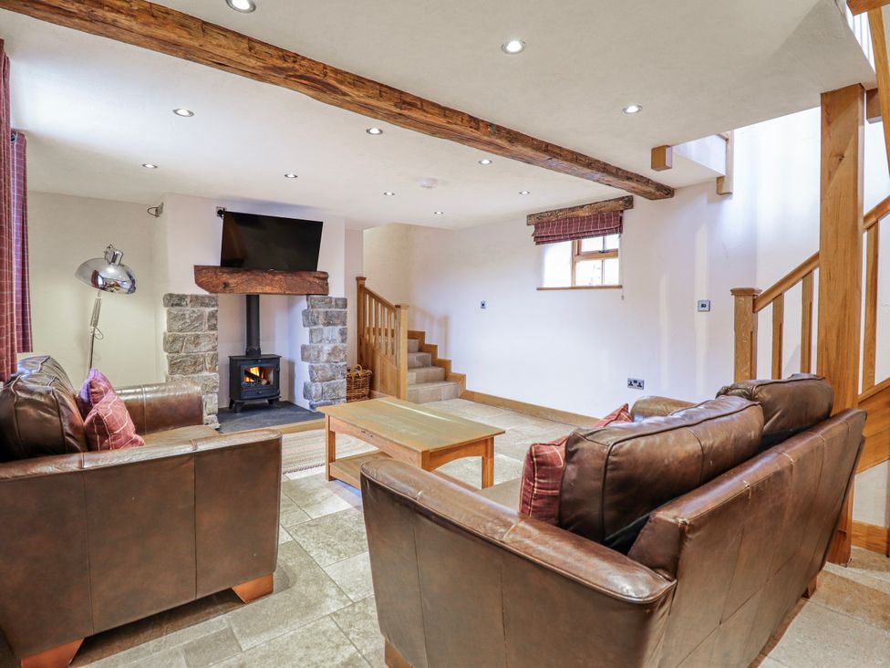 A living room with a fireplace and television at Briws and 963354 together they sleep 35