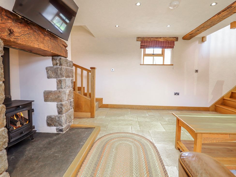 A living room with a fireplace and staircase at Briws and 963354 together they sleep 35