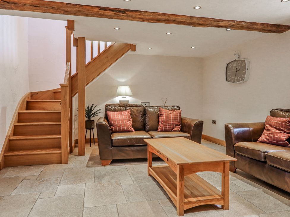 A living room with sofa, coffee table and staircase at Briws and 963354 together they sleep 35