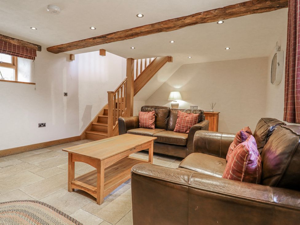 A living room with seating and a staircase at Briws and 963354 together they sleep 35