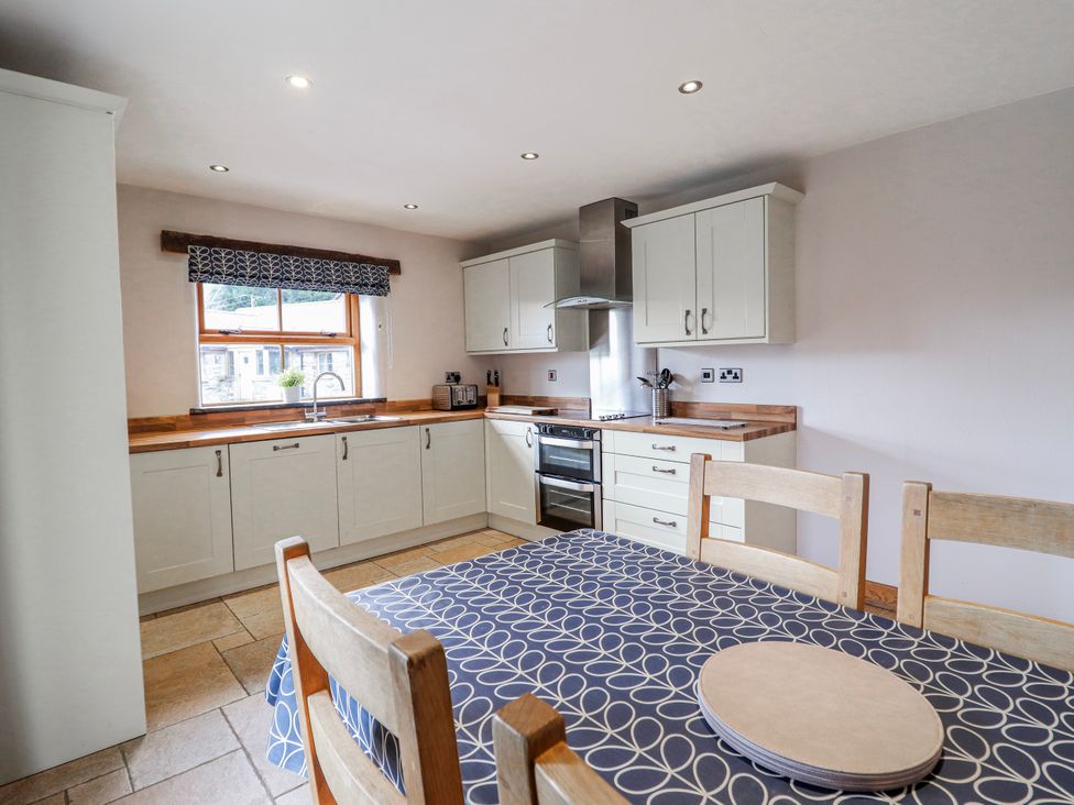 A kitchen with cabinets and a table at Briws and 963354 together they sleep 35