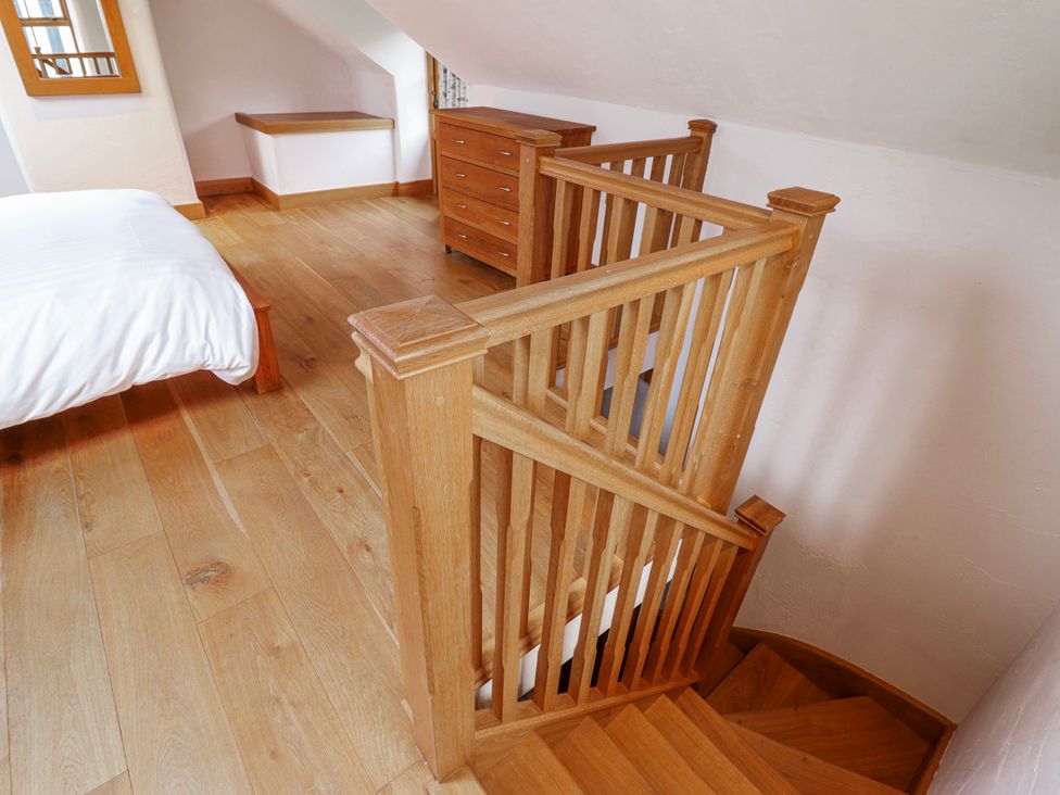 A bedroom with a bed and staircase at Briws and 963354 together they sleep 35