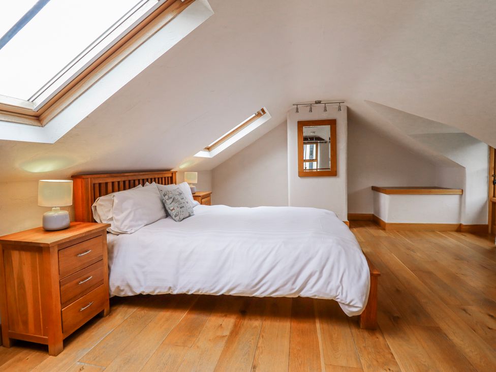 A bedroom with a bed and nightstand at Briws and 963354 together they sleep 35