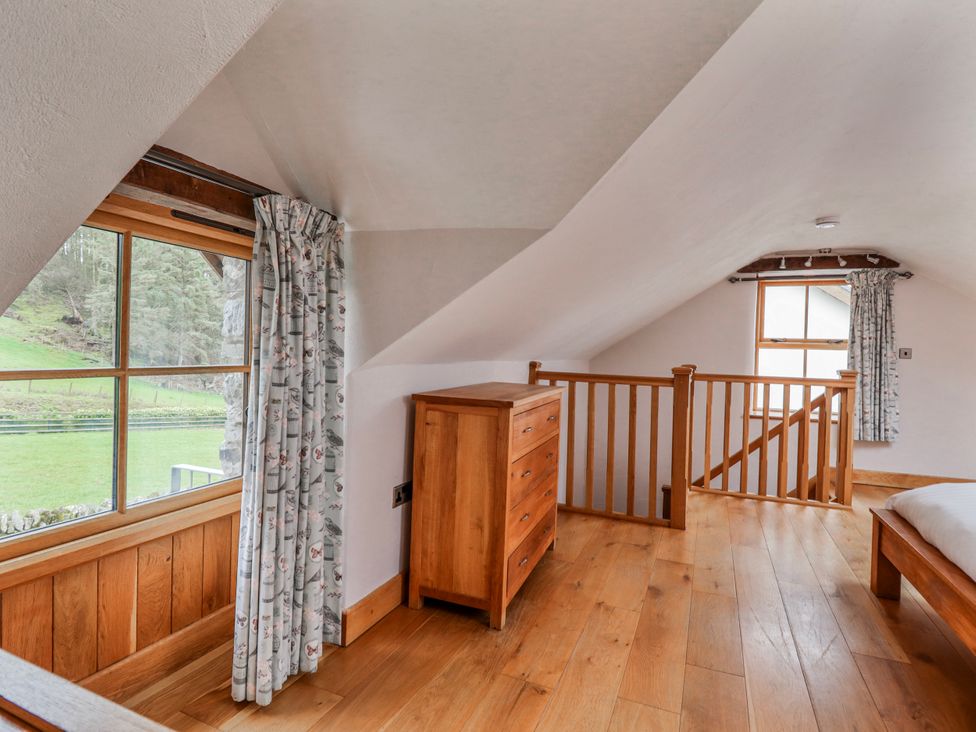 A bedroom with a dresser and window at Briws and 963354 together they sleep 35