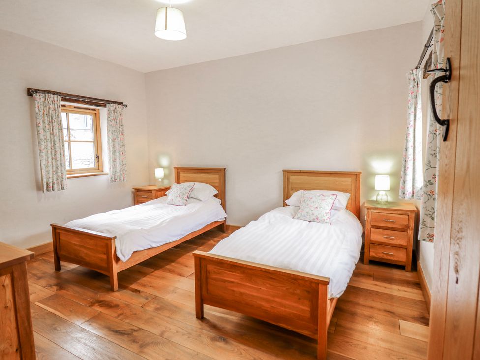 A bedroom with two single beds and a window at Briws and 963354 together they sleep 35