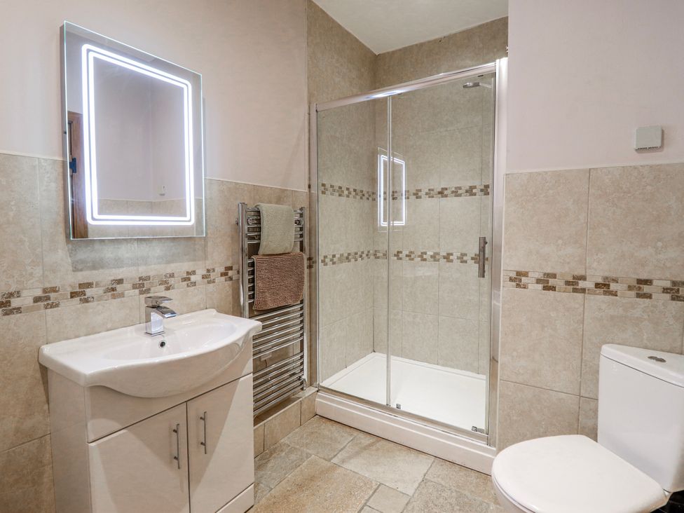 A bathroom with a shower, sink, and toilet at Briws and 963354 together they sleep 35