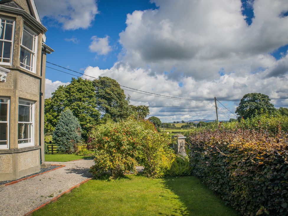 A garden with plants and trees at The Farm House in Bala
