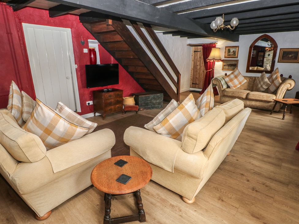 A living room with sofas and a television at Maesgwyn in Bridell near Cardigan