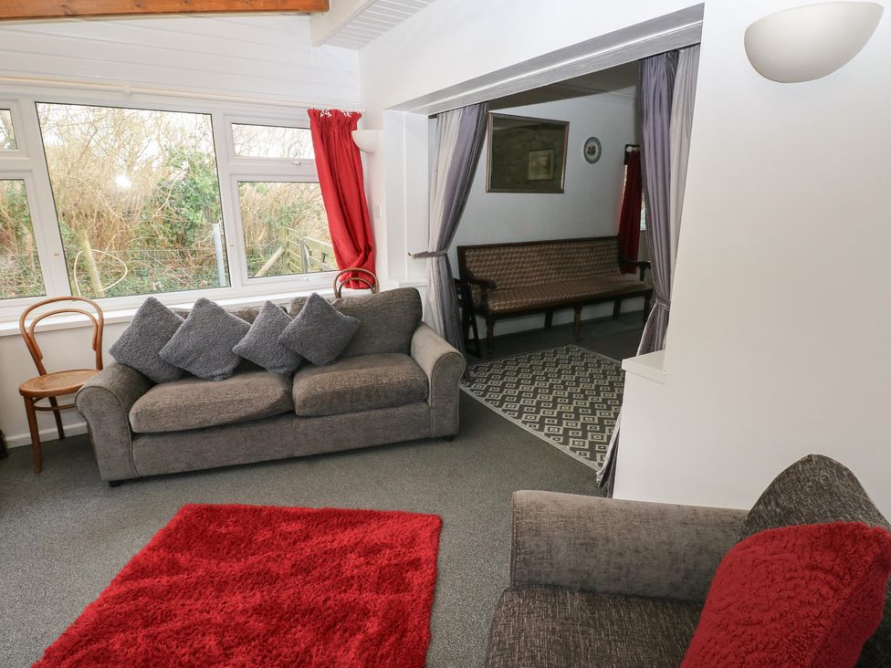 A living room with a sofa and chair at Maesgwyn in Bridell near Cardigan