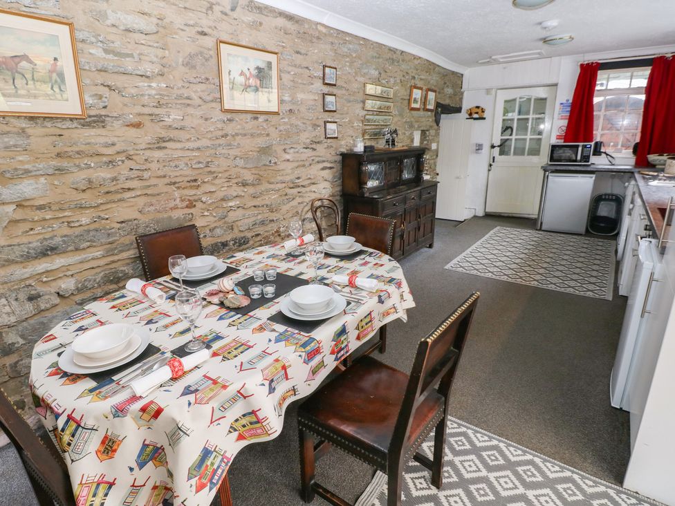 A dining room with a table set for meals at Maesgwyn Bridell near Cardigan
