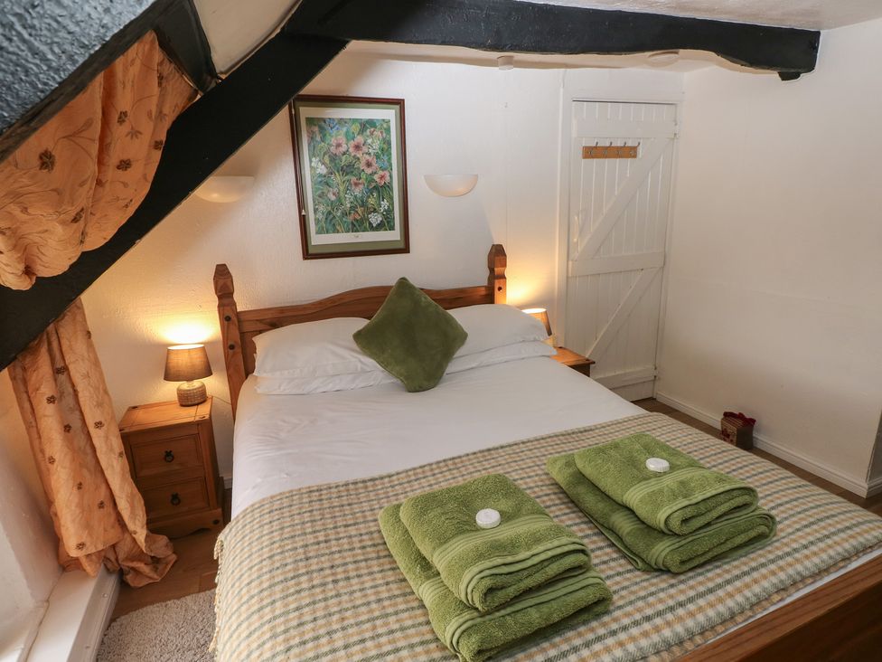 A bedroom with a bed and towels at Maesgwyn Bridell near Cardigan