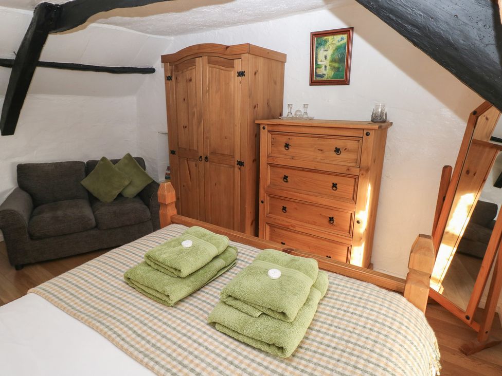 A bedroom with a bed and storage furniture at Maesgwyn in Bridell near Cardigan