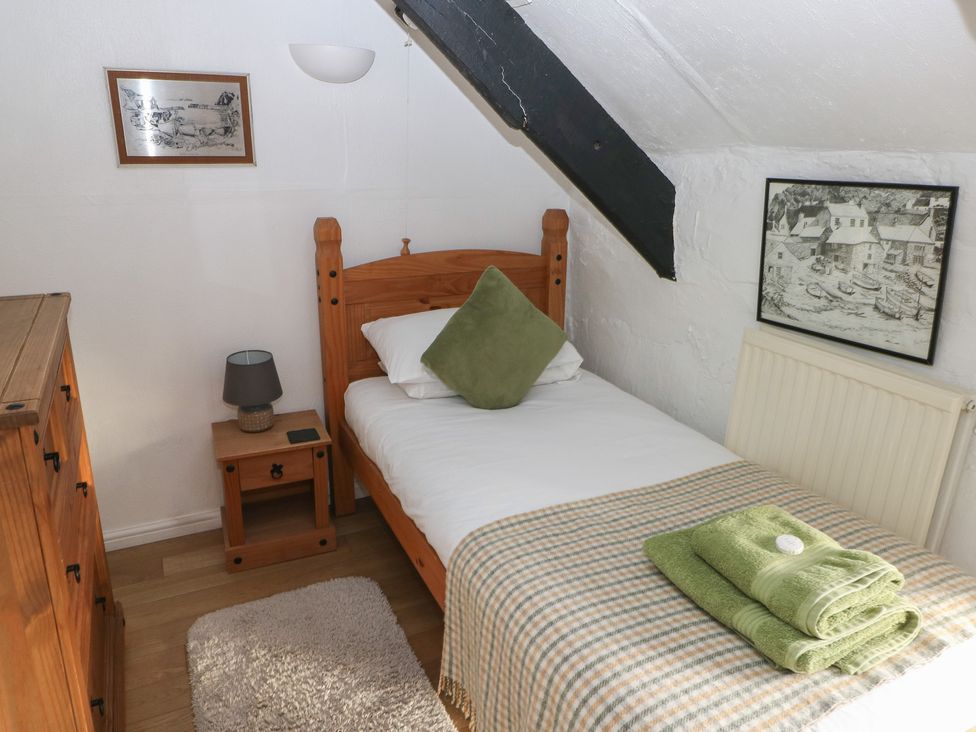 A bedroom with a single bed and chest of drawers at Maesgwyn Bridell near Cardigan