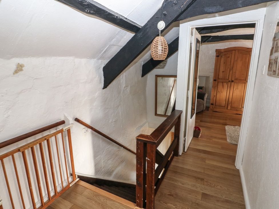 A hallway with a staircase leading down at Maesgwyn in Bridell near Cardigan