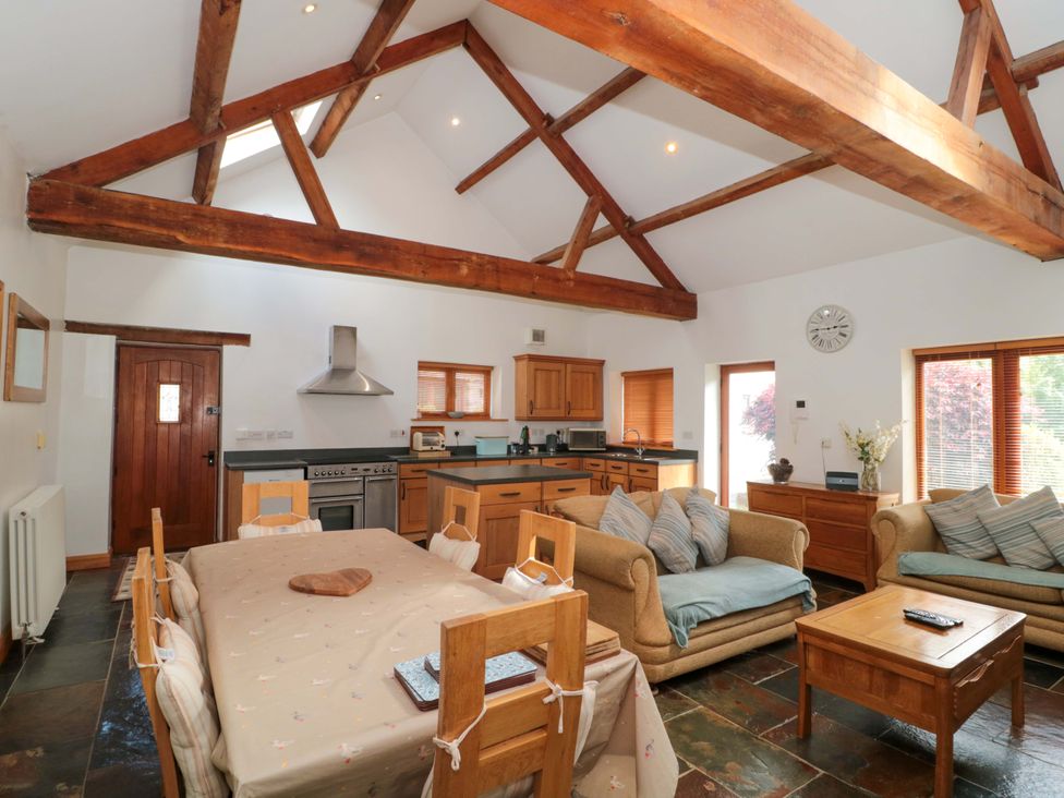 A kitchen with wooden furniture and appliances at Riverside Barn Gilwern near Crickhowell and Abergavenny