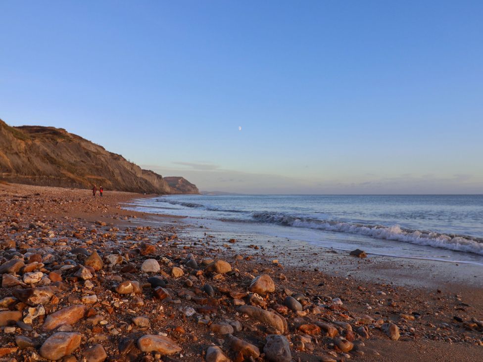 A beach with rocks and cliffs in the background at Rowdens Barn Winterborne Stickland