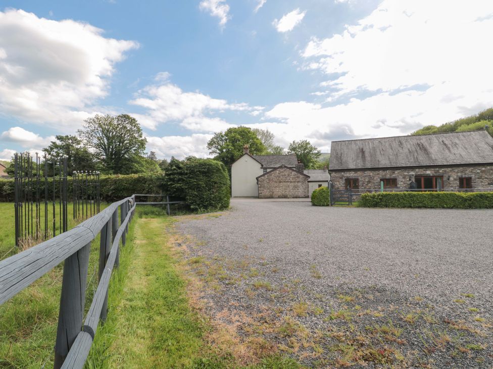 An outdoor area with gravel and buildings at Longside in Gilwern