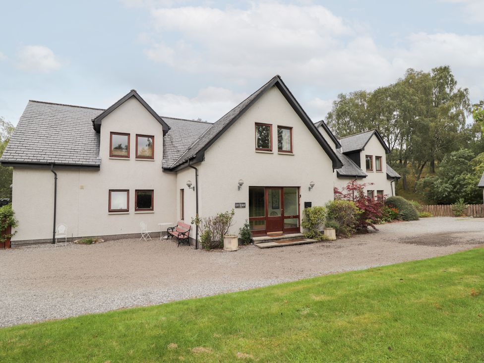 A house with multiple windows and a garden at An Torr Newtonmore