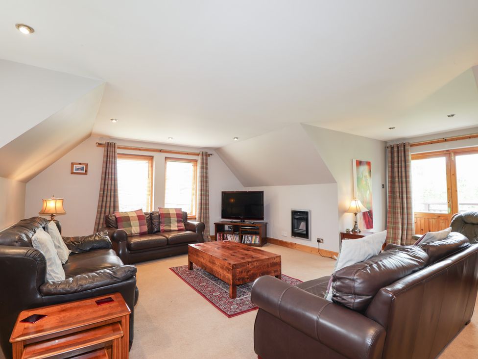 A living room with sofas and a coffee table at An Torr in Newtonmore