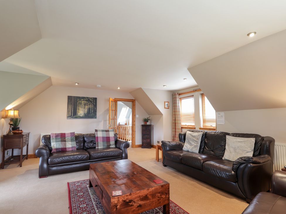 A living room with sofas and a coffee table at An Torr in Newtonmore