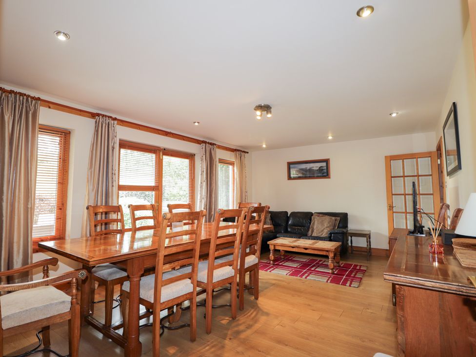 A dining room with a wooden table and chairs at An Torr in Newtonmore