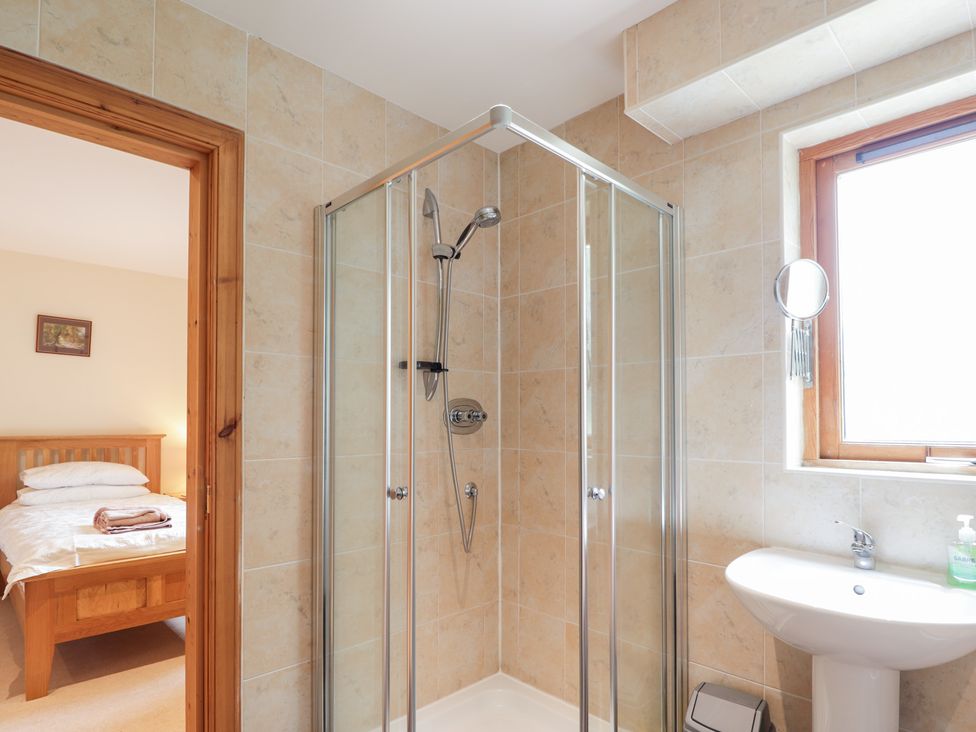 A bathroom with a shower and sink at An Torr in Newtonmore
