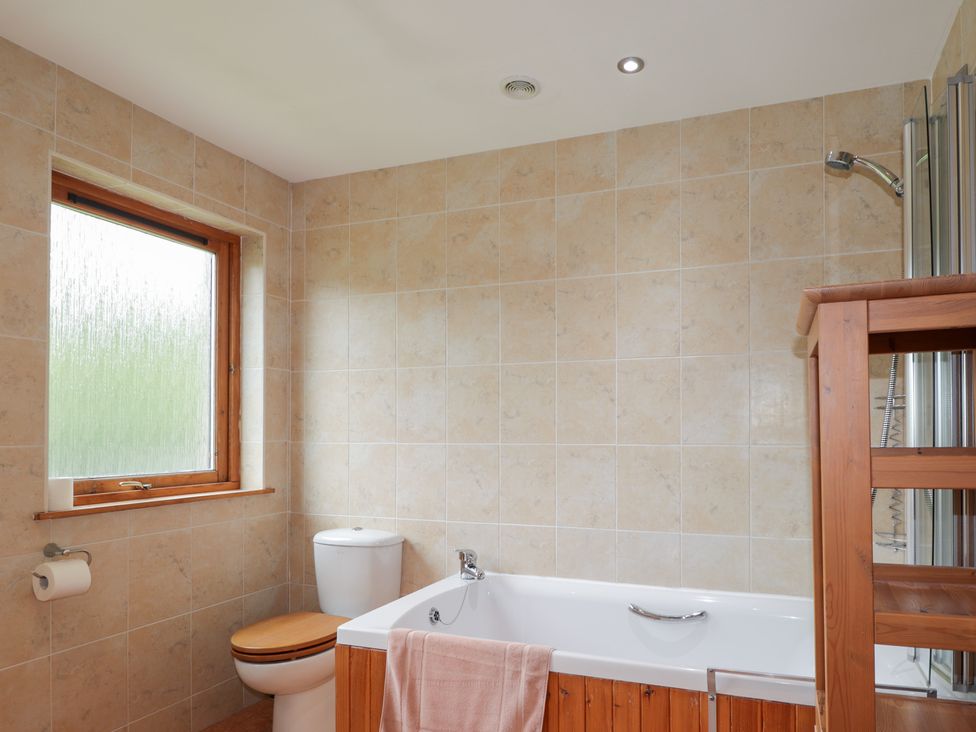 A bathroom with a bathtub and toilet at An Torr in Newtonmore