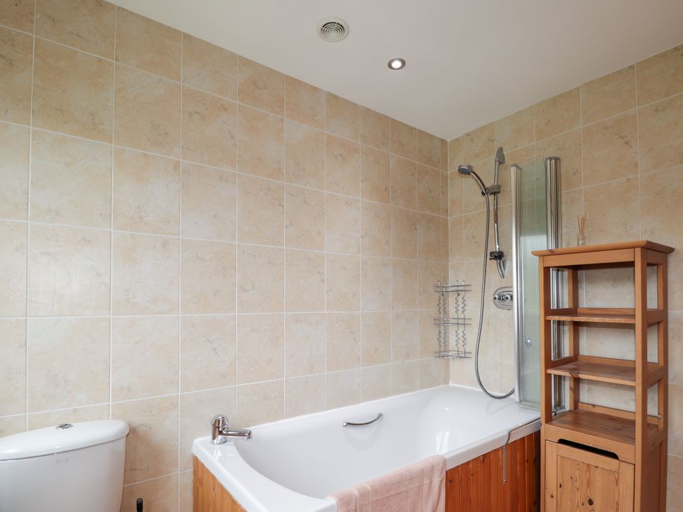 A bathroom with a bathtub and shower at An Torr in Newtonmore