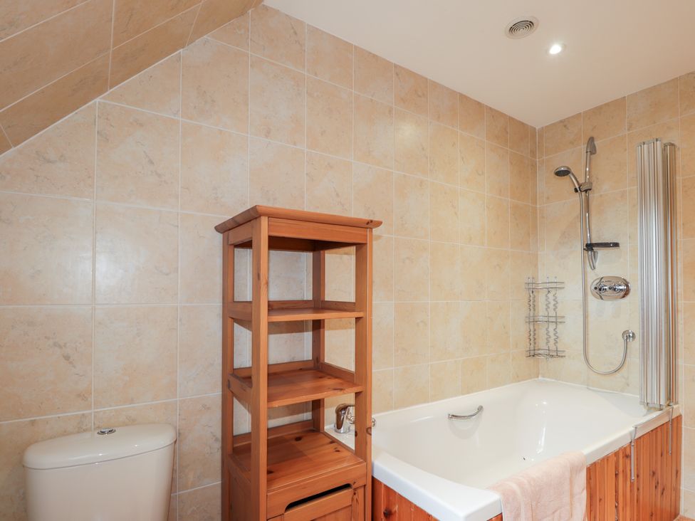 A bathroom with a bathtub and shower at An Torr in Newtonmore