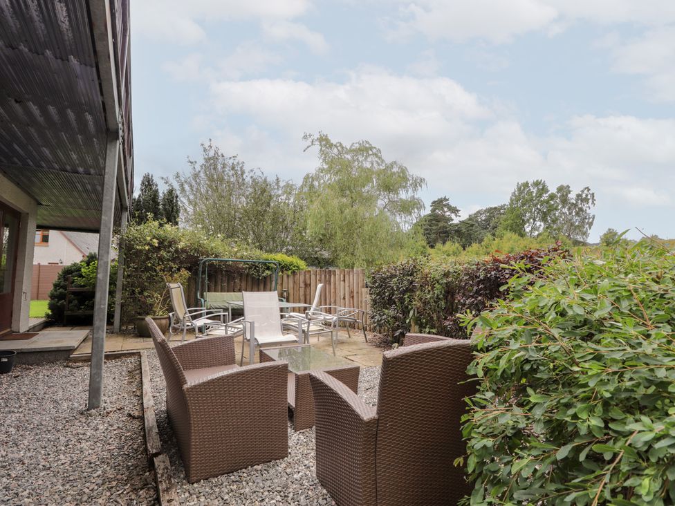 A garden with seating and plants at An Torr in Newtonmore