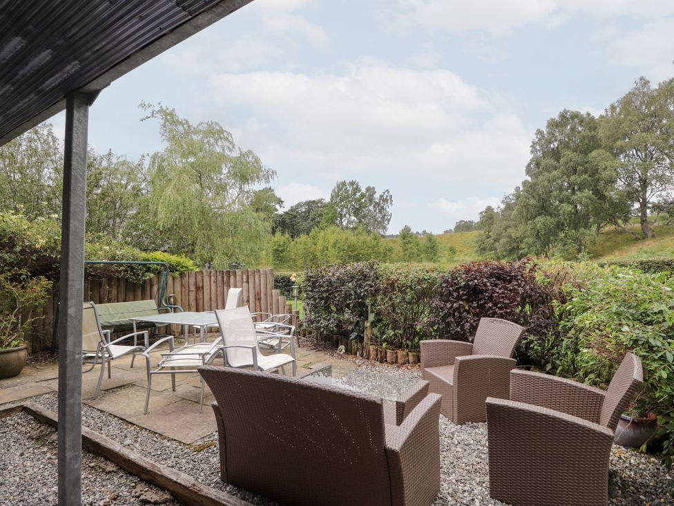 A garden with patio furniture and plants at An Torr in Newtonmore