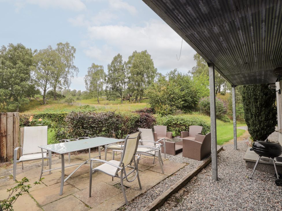 An outdoor seating area with a table and chairs at An Torr in Newtonmore