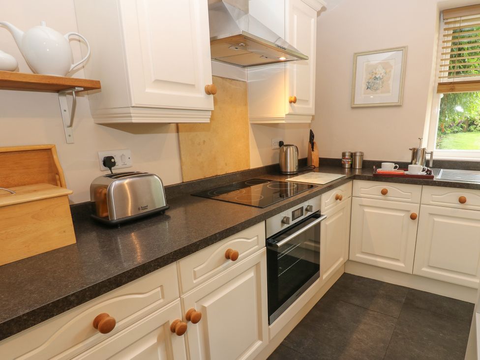 A kitchen with appliances and a countertop at Cross Beck Cottage in Grinton near Reeth