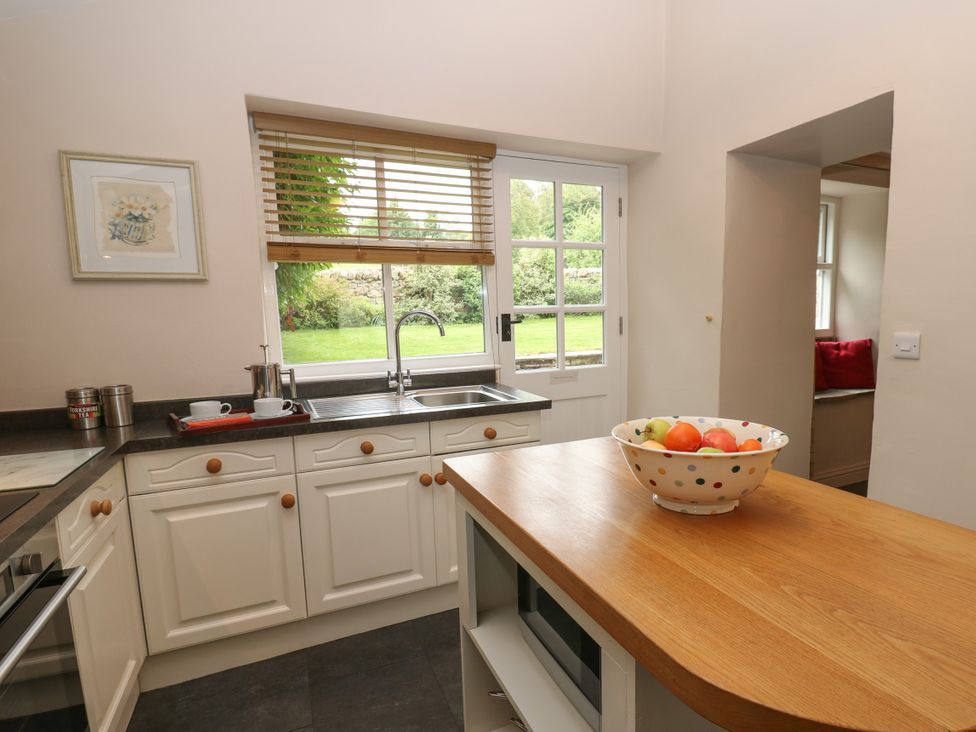A kitchen with a sink and fruit bowl at Cross Beck Cottage in Grinton near Reeth