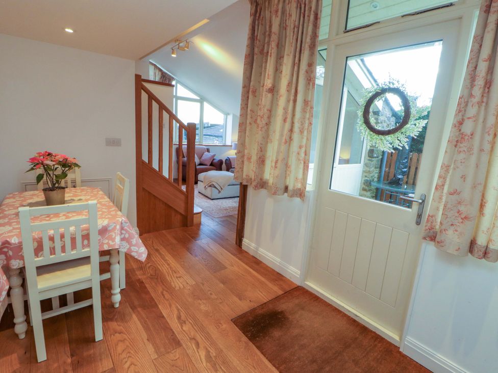 A dining room with a table and chairs at Hawkrigg Cottage in Kirkby Lonsdale