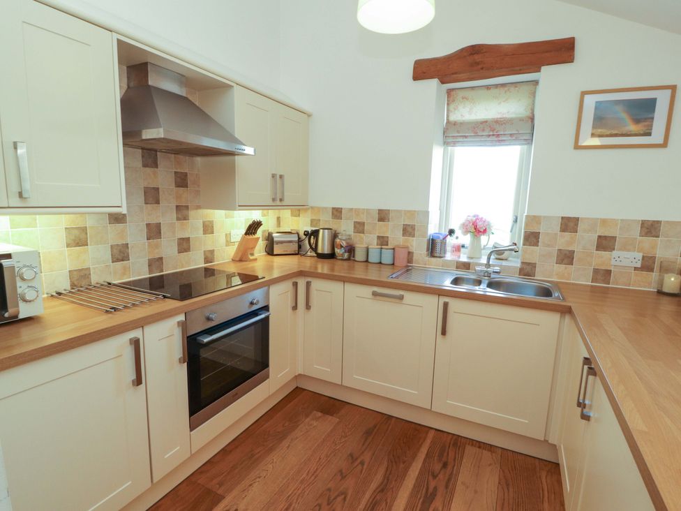 A kitchen with appliances and countertop at Hawkrigg Cottage in Kirkby Lonsdale