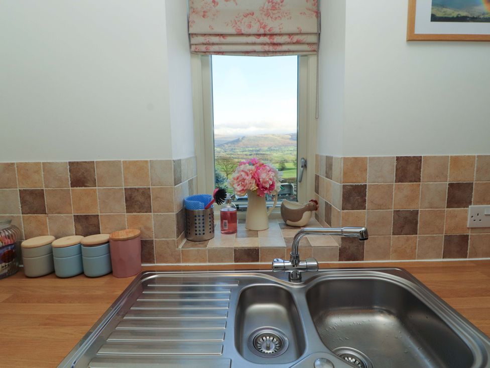 A kitchen with a sink and window at Hawkrigg Cottage in Kirkby Lonsdale