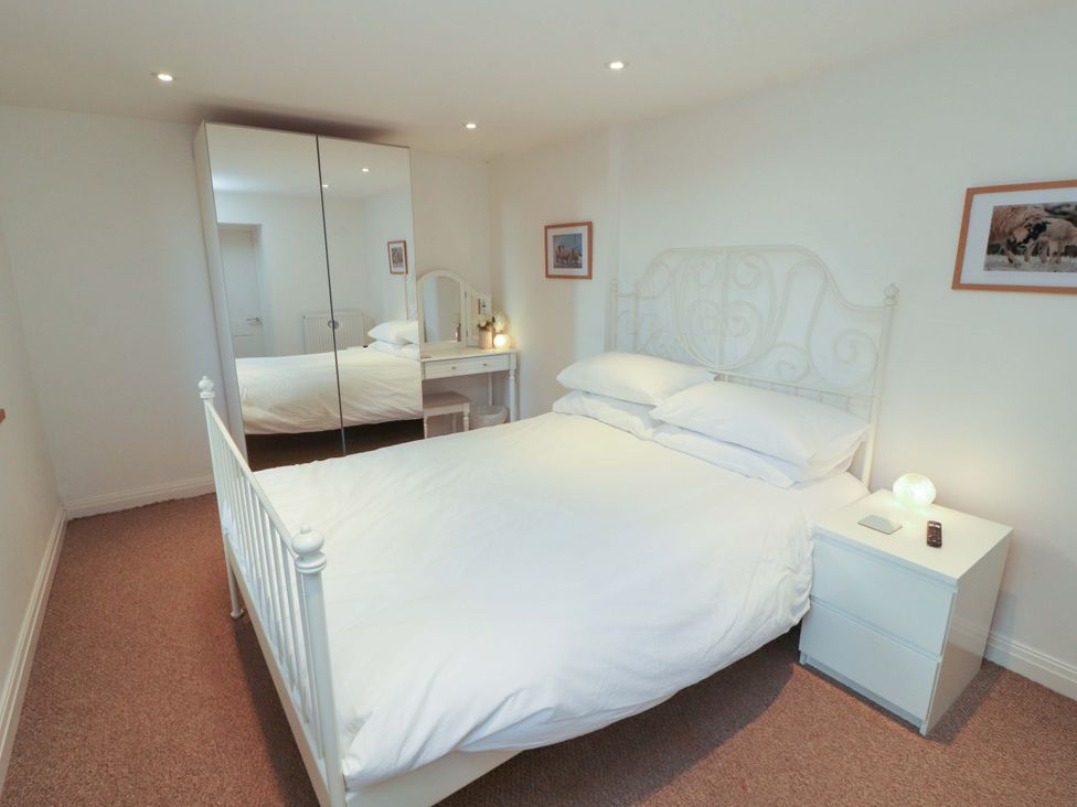 A bedroom with a bed and a dresser at Hawkrigg Cottage in Kirkby Lonsdale