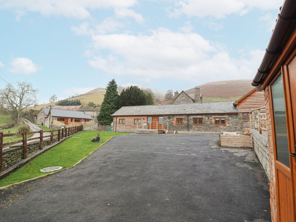 A view of buildings and a road at Rhianwen, Plas Moelfre Hall Barns Llanrhaeadr-ym-Mochnant