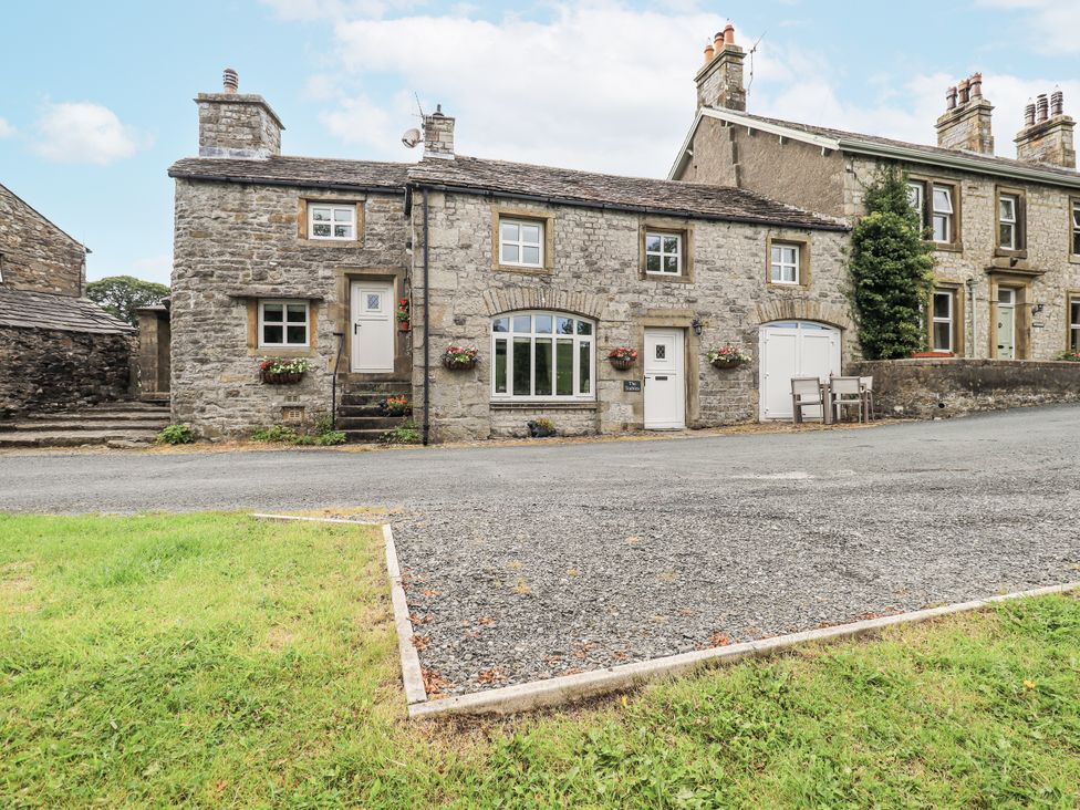 A stone house with flowers on the exterior at The Stables in Horton-in-Ribblesdale near Settle