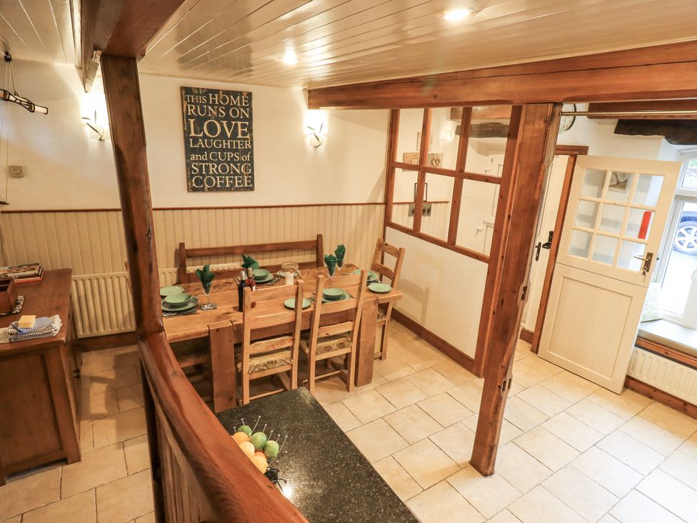 A dining room with wooden furniture and a decorative sign at The Stables in Horton-in-Ribblesdale near Settle