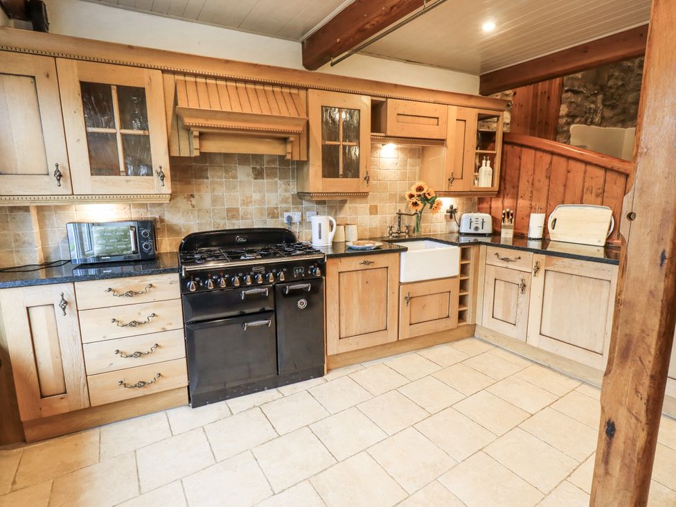 A kitchen with a cooker and sink at The Stables in Horton-in-Ribblesdale near Settle