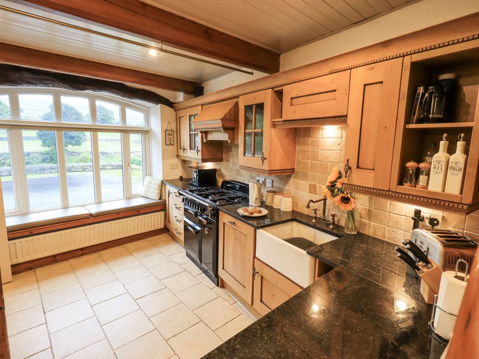A kitchen with a stove and sink at The Stables in Horton-in-Ribblesdale near Settle