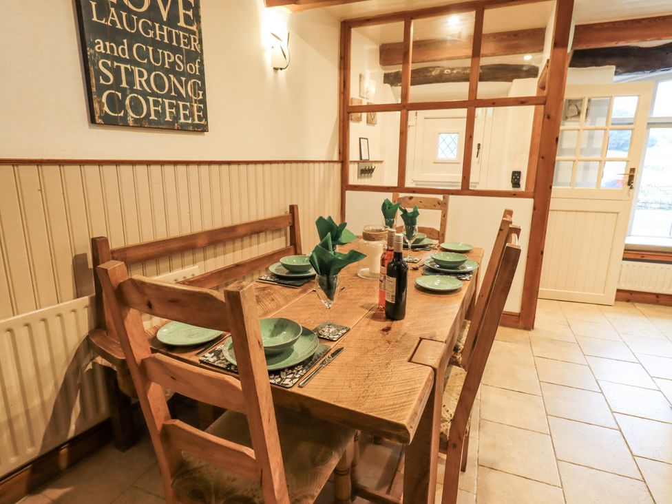 A dining room with a wooden table set for a meal at The Stables in Horton-in-Ribblesdale near Settle