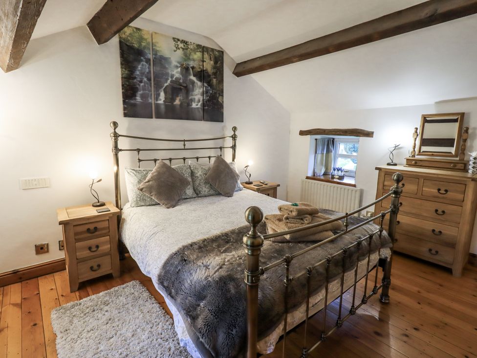 A bedroom with a bed and furniture at The Stables in Horton-in-Ribblesdale near Settle