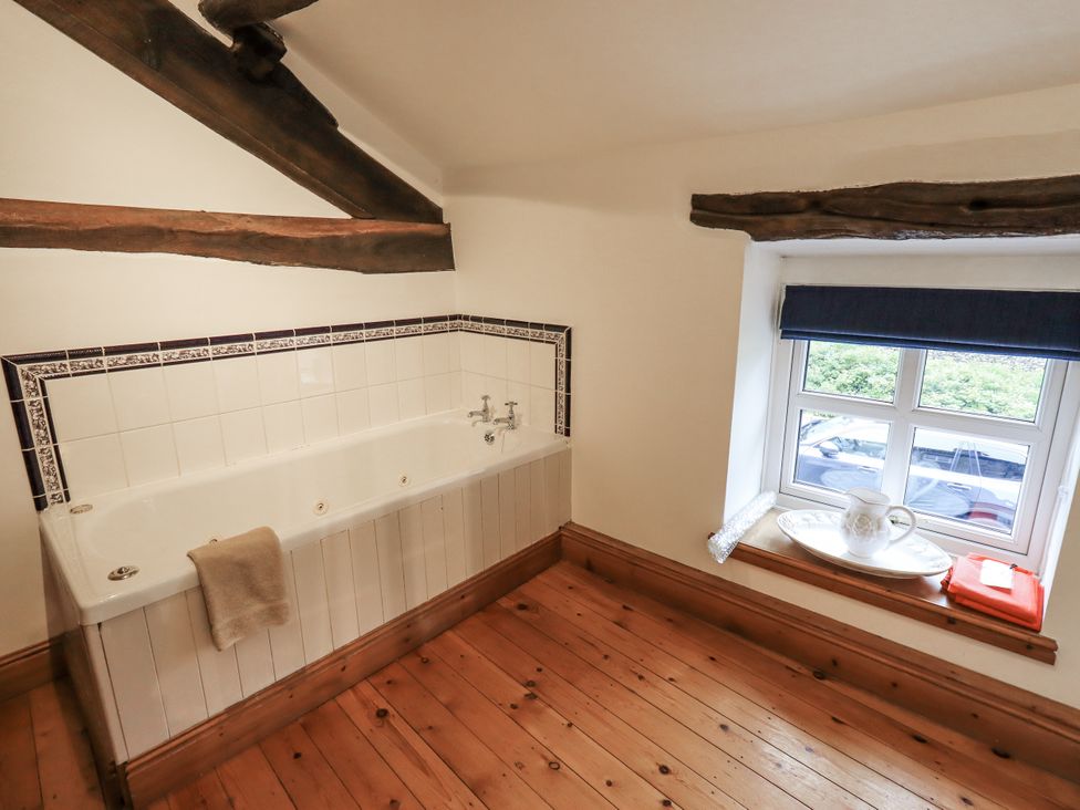 A bathroom with a bathtub and a window at The Stables in Horton-in-Ribblesdale near Settle