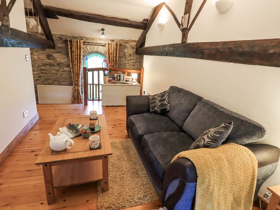A living room with a sofa and coffee table at The Stables in Horton-in-Ribblesdale near Settle
