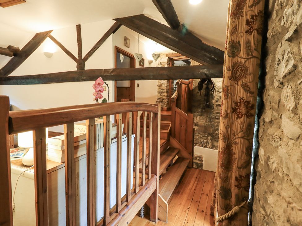 A landing with wooden stairs and railing at The Stables in Horton-in-Ribblesdale near Settle